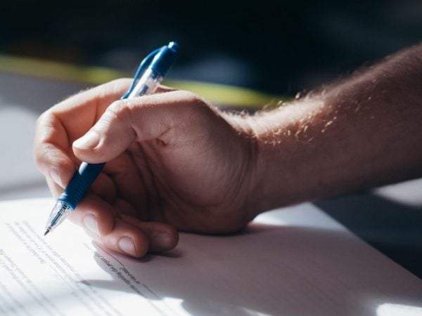 hand with pen and paper