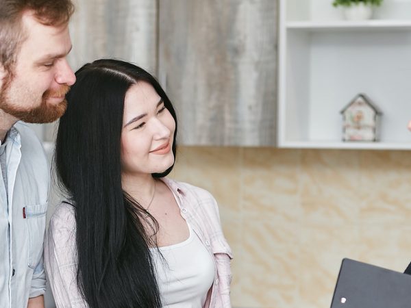 couple talking to a woman with a file