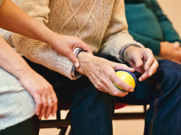 older man holding ball