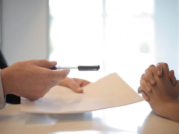 hands holding pen and paper